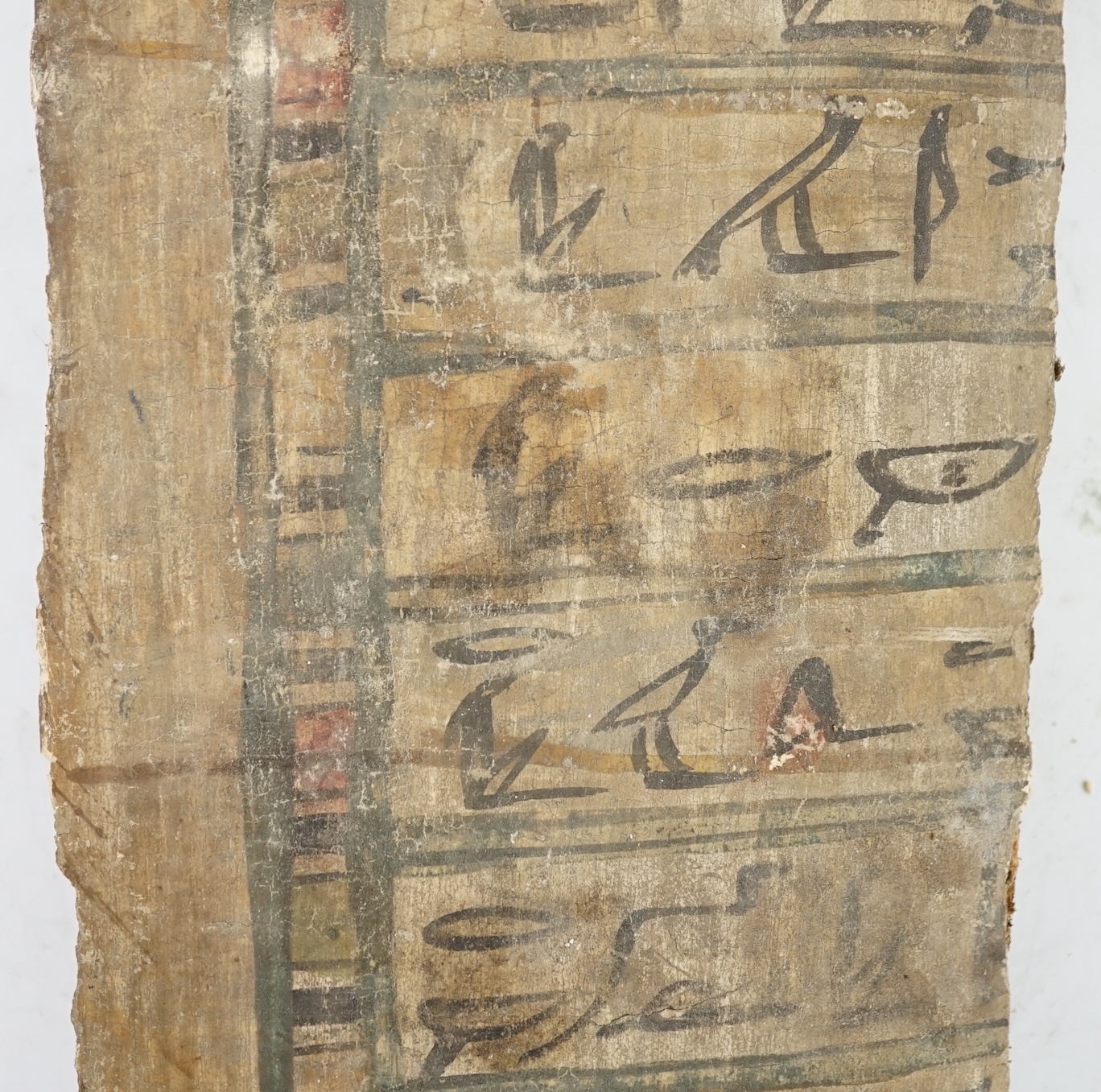 An Ancient Egyptian painted gesso, linen and wood fragment from a coffin or canopic chest, probably late Kingdom